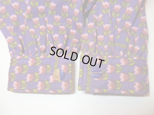 左袖口ボタンの紫部分が半分取れています